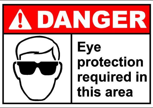 A danger sign with an image of a man wearing sunglasses.