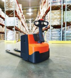 A large warehouse with a forklift in it.