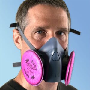 A man wearing a mask with pink filters around his face.