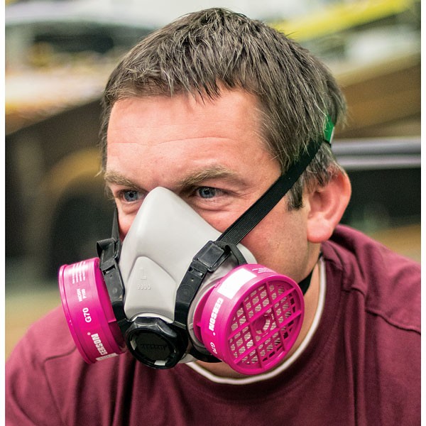A man wearing a respirator and ear muffs.